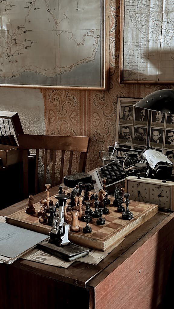 A nostalgic scene of a chess set on an antique desk surrounded by vintage maps in warm lighting.