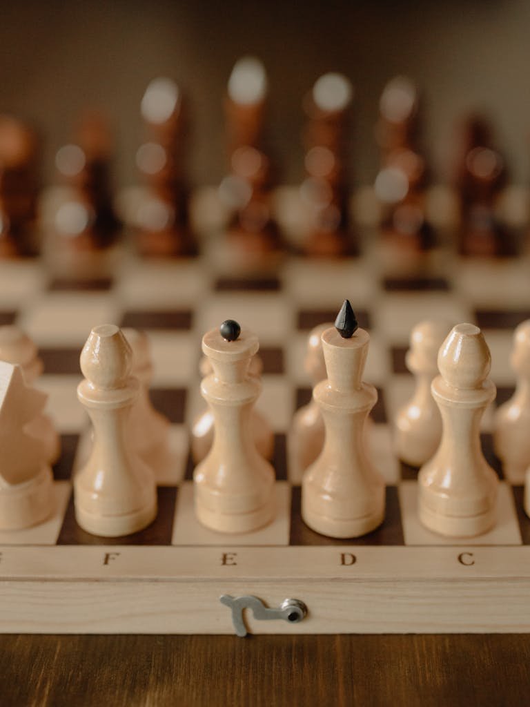 Close-up view of chess pieces on a classic wooden board, focusing on strategy and challenge.